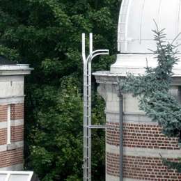 Ladder with lifeline system and top extension for roof access Ladder with top lifeline extension for roof access on a tower.